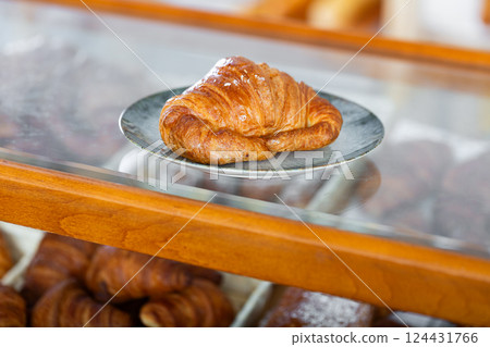 Showcase of traditional bakery shop with appetizing croissants Showcase of traditional bakery shop with appetizing croissants 124431766