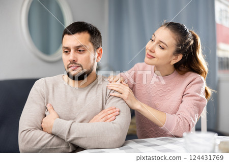 Wife consoling her sad husband 124431769