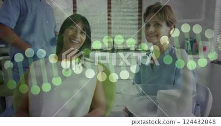 Image of dna strands over caucasian female doctor with biracial female patient in hospital Image of dna strands over caucasian female doctor with biracial female patient in hospital 124432048