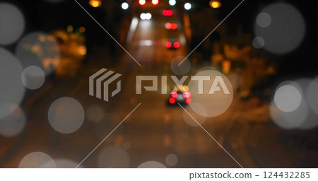 Bokeh light image over blurred night street scene with traffic lights 124432285