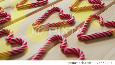 Candy cane hearts on wooden surface with bokeh lights image Candy cane hearts on wooden surface with bokeh lights image 124432287