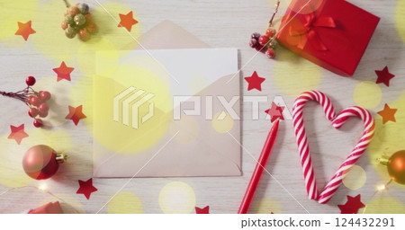 Christmas decorations with candy cane and envelope over festive stars image Christmas decorations with candy cane and envelope over festive stars image 124432291