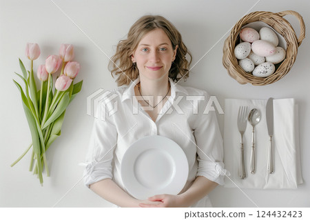 A woman in a white shirt with easter table setting and decorated background A woman in a white shirt with easter table setting and decorated background 124432423