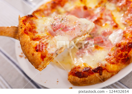 Delicious pizza with prosciutto Delicious pizza with prosciutto 124432654