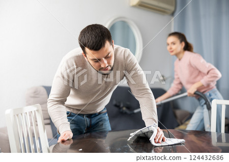 Young couple cleaning table in living room 124432686