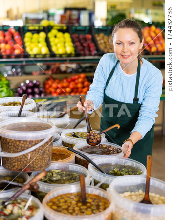 woman seller offers to buy olives woman seller offers to buy olives 124432736