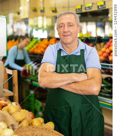 vegetable salesman in supermarket vegetable salesman in supermarket 124432899