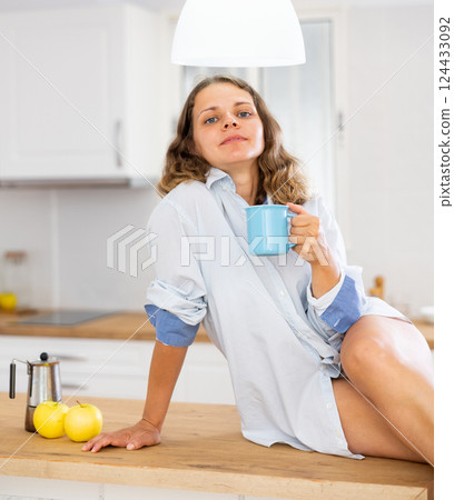 Portrait of smiling girl sitting on table Portrait of smiling girl sitting on table 124433092