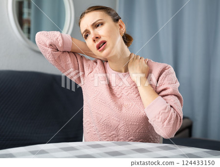 Young woman suffering from neck pain Young woman suffering from neck pain 124433150