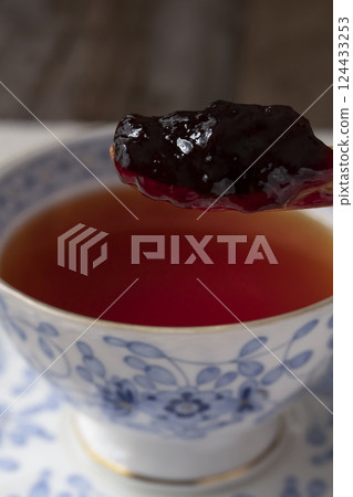 Russian tea: Put jam into tea with a spoon. Pour tea. 124433253
