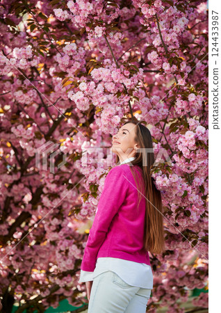 Woman allergic enjoying after treatment from seasonal allergy at spring. Portrait of happy beautiful woman smiling in front of blooming sakura tree at springtime. Spring allergy concept. Woman allergic enjoying after treatment from seasonal allergy at spring. Portrait of happy beautiful woman smiling in front of blooming sakura tree at springtime. Spring allergy concept. 124433987
