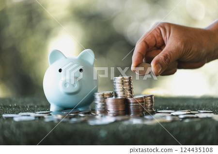 Saving money concept preset by female hand putting money coin stack growing business. Asian woman making stack of coin, planning budget, investment strategy, saving money, checking finances Saving money concept preset by female hand putting money coin stack growing business. Asian woman making stack of coin, planning budget, investment strategy, saving money, checking finances 124435108