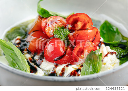 Gourmet appetizer with tomato and soft cheese Gourmet appetizer with tomato and soft cheese 124435121