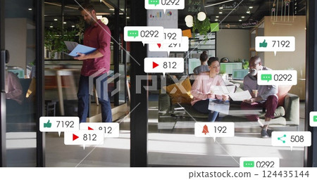 Image of social media notifications over diverse colleagues talking at casual office 124435144