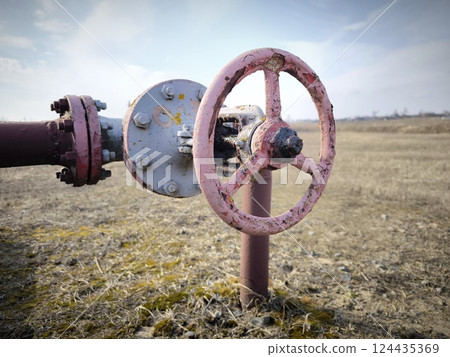 Old Gas pipes with pressure valves. Oil pipeline against sky. Pipeline for pumping oil. Gas valves 124435369