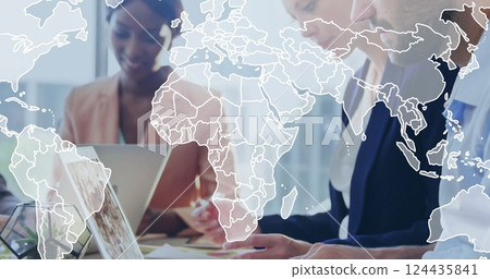 Image of world map over diverse colleagues working in office 124435841