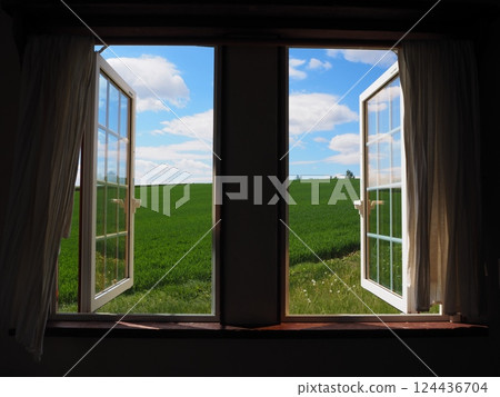 Blue sky and green hills seen from the window 124436704