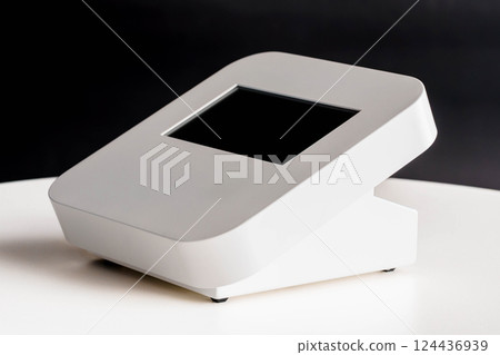 Modern White Electronic Device with Touchscreen Display on White Surface Against Dark Background 124436939