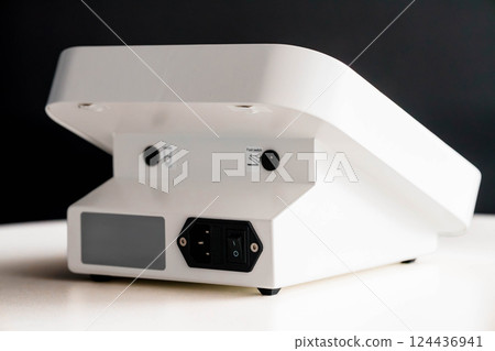 Rear View Close-Up of Modern White Electronic Device Showing Power Button and Connectors on Plain Surface Rear View Close-Up of Modern White Electronic Device Showing Power Button and Connectors on Plain Surface 124436941