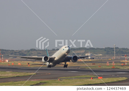 Cathay Pacific plane taking off, passenger plane ascending 124437469