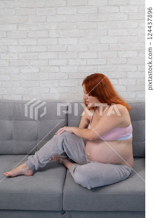 Caucasian pregnant woman suffering from leg cramps. Third trimester.  124437896