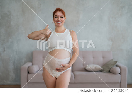 Happy Pregnant Woman Recommends Adult Diapers.  124438095