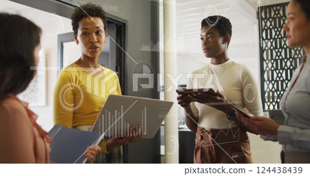 Image of financial data processing over diverse business people in office Image of financial data processing over diverse business people in office 124438439