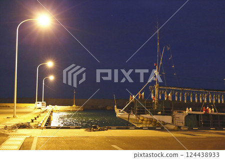 Fishing boats anchored in a fishing harbor at night Fishing boats anchored in a fishing harbor at night 124438933
