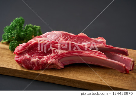 Raw lamb chops on a wooden cutting board 124438970