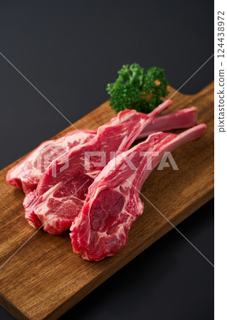 Raw lamb chops on a wooden cutting board 124438972