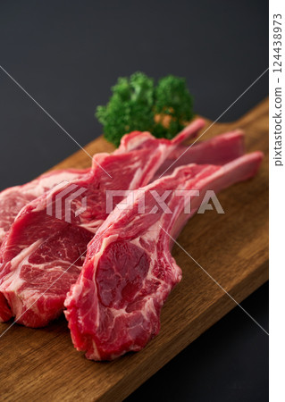 Raw lamb chops on a wooden cutting board 124438973