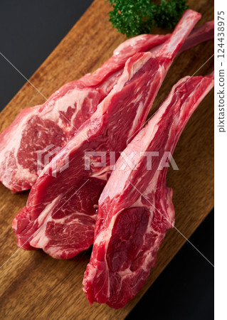 Raw lamb chops on a wooden cutting board Raw lamb chops on a wooden cutting board 124438975