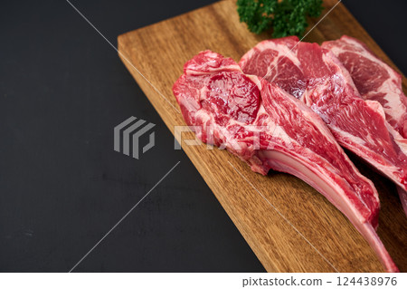Raw lamb chops on a wooden cutting board 124438976