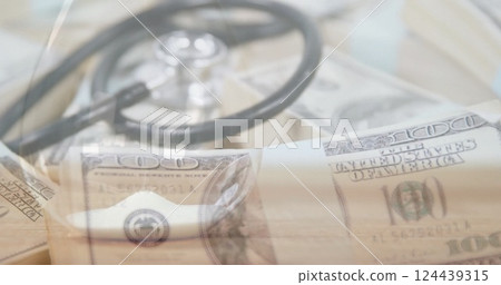 Image of stethoscope and banknotes over hourglass 124439315