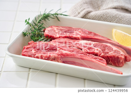 Raw lamb chops arranged on a white tray Raw lamb chops arranged on a white tray 124439956