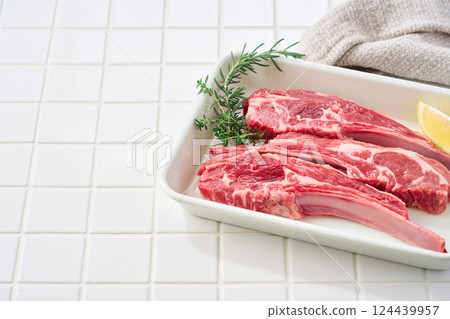 Raw lamb chops arranged on a white tray Raw lamb chops arranged on a white tray 124439957