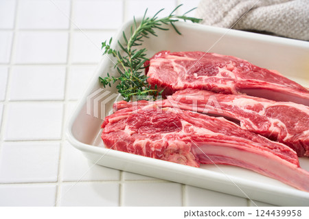 Raw lamb chops arranged on a white tray Raw lamb chops arranged on a white tray 124439958