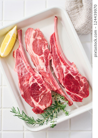 Raw lamb chops arranged on a white tray 124439970