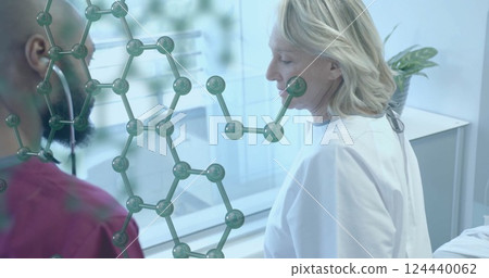Image of element structure over diverse male doctor using stethoscope on senior female patient Image of element structure over diverse male doctor using stethoscope on senior female patient 124440062