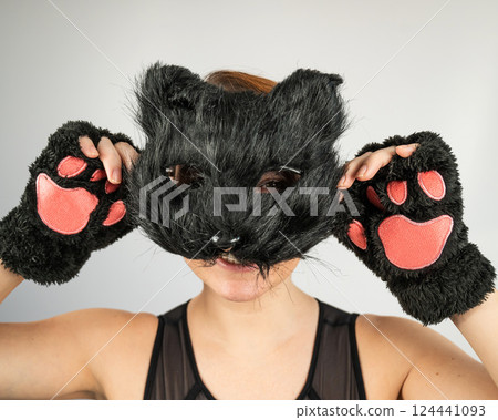 Portrait of a woman in a cat costume on a white background. Quadrober. Portrait of a woman in a cat costume on a white background. Quadrober. 124441093