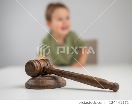 Little boy behind judge's gavel.  124441371