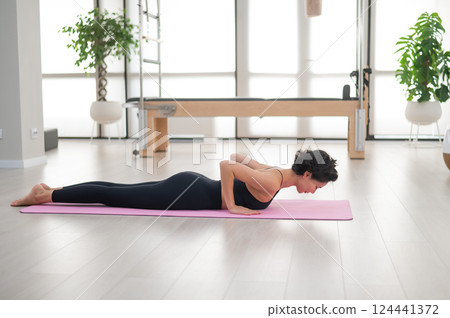 Asian woman doing yoga in studio.  124441372