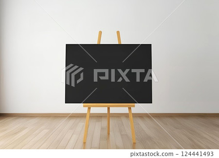 A black board placed on an easel in a simple room 124441493