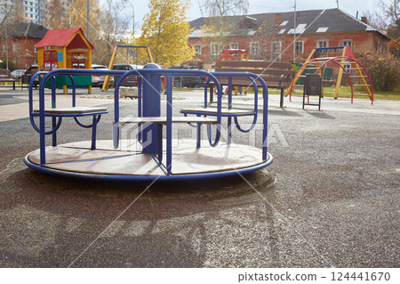 empty carousel on a playground on an autumn sunny day empty carousel on a playground on an autumn sunny day 124441670