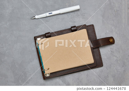 Design concept - Top view open notebook with kraft paper in a leather cover. Background for mockup 124441678