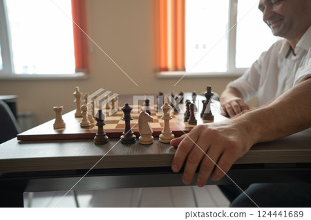 Caucasian man thinking about a chess move.  124441689