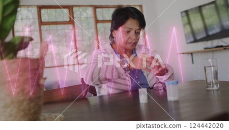 Image of cardiograph over senior biracial woman taking pills Image of cardiograph over senior biracial woman taking pills 124442020