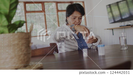 Image of cardiograph over senior biracial woman taking pills Image of cardiograph over senior biracial woman taking pills 124442031