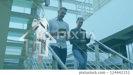 Image of house and key over caucasian colleagues walking in office 124442151