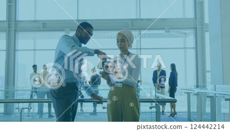 Image of people icons and data processing over diverse business people in office Image of people icons and data processing over diverse business people in office 124442214